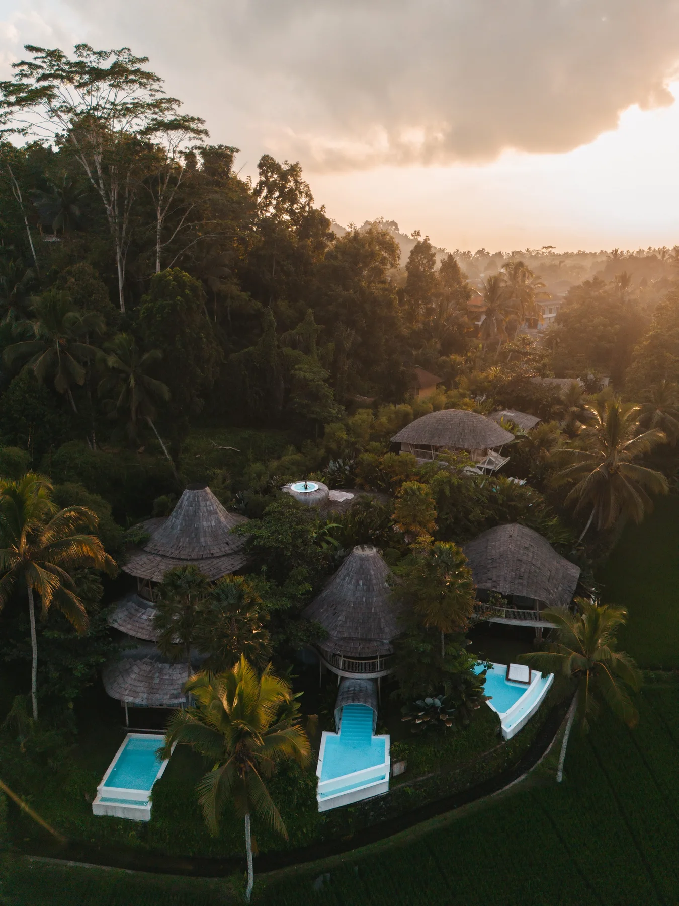 Ecosix Bali’s bamboo villas and turquoise pools surrounded by jungle at sunset