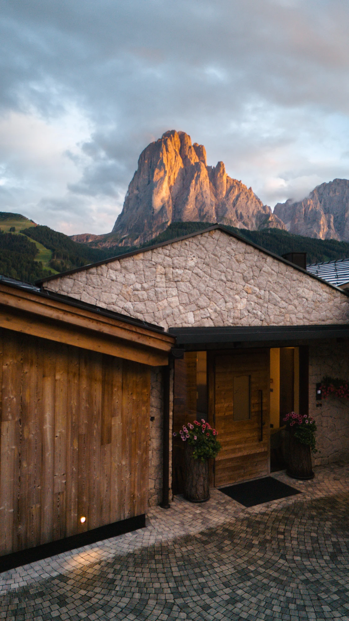 Chalet Lefiro beneath the sunlit Sassolungo massif in Val Gardena